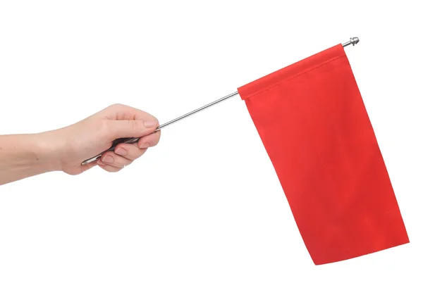 Mano sosteniendo una bandera roja aislada sobre fondo blanco. Pon tu... — Foto de Stock