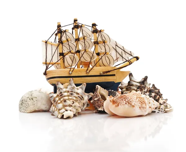 Model classic boat on sea shells — Stock Photo, Image