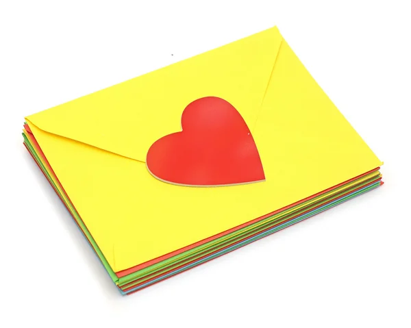 A red heart on pile colorful envelopes over white background — Stock Photo, Image