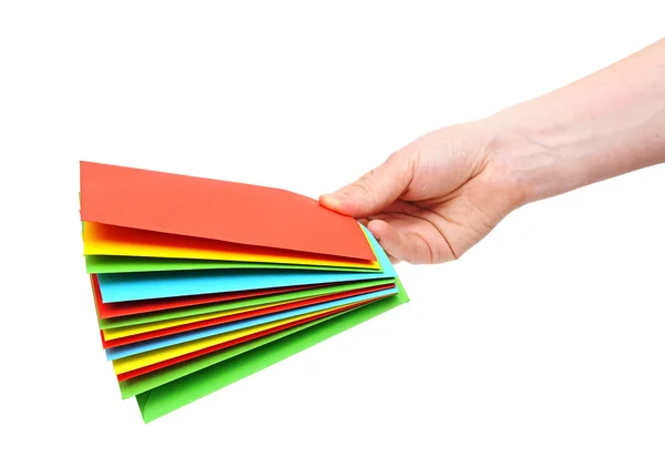 Woman hand holding pile colorful envelopes isolated on white — Stock Photo, Image