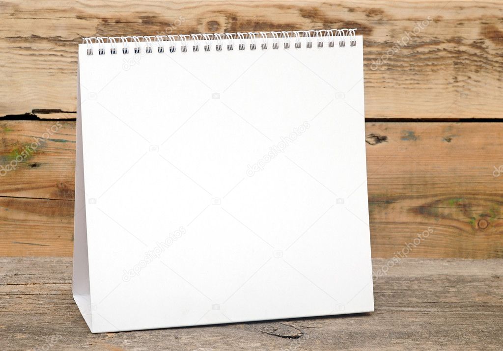 blank desk calendar on wooden table