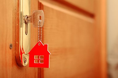 Symbol of the house and stick the key in the keyhole clipart