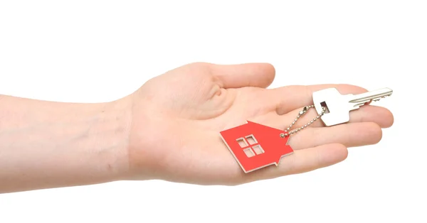 Hand holding key with a keychain in the shape of the house on th — Stock Photo, Image