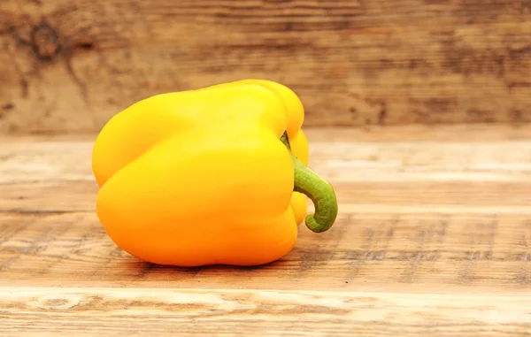 Yellow paprika on wooden background — Stock Photo, Image