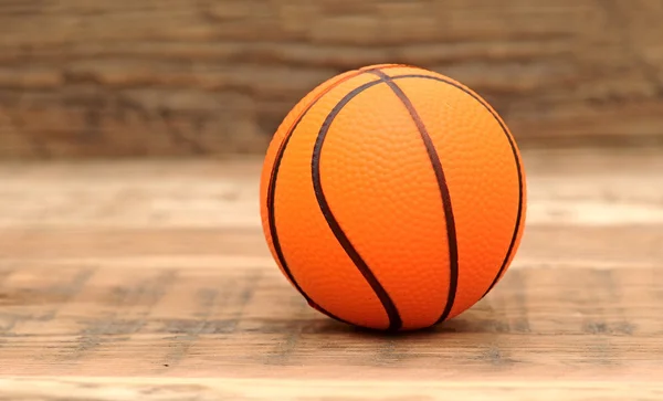 Toy basketball on wood background — Stock Photo, Image