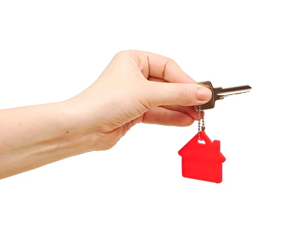 Hand holding key with a keychain in the shape of the house. Hous — Stock Photo, Image