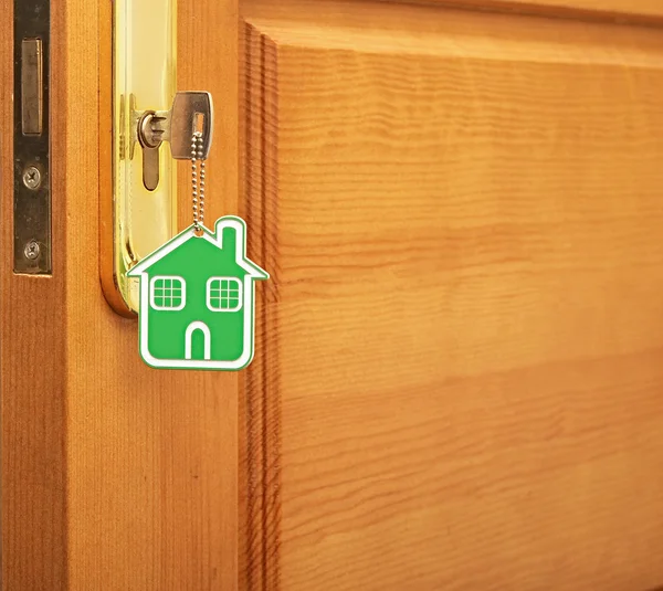 Symbol of the house and stick the key in the keyhole — Stock Photo, Image