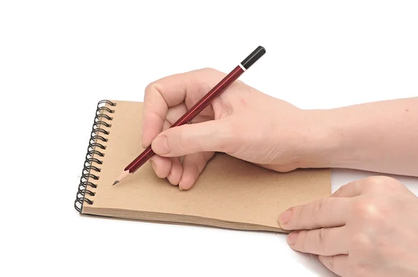 Female hand drawing on brown recycled paper — Stock Photo, Image