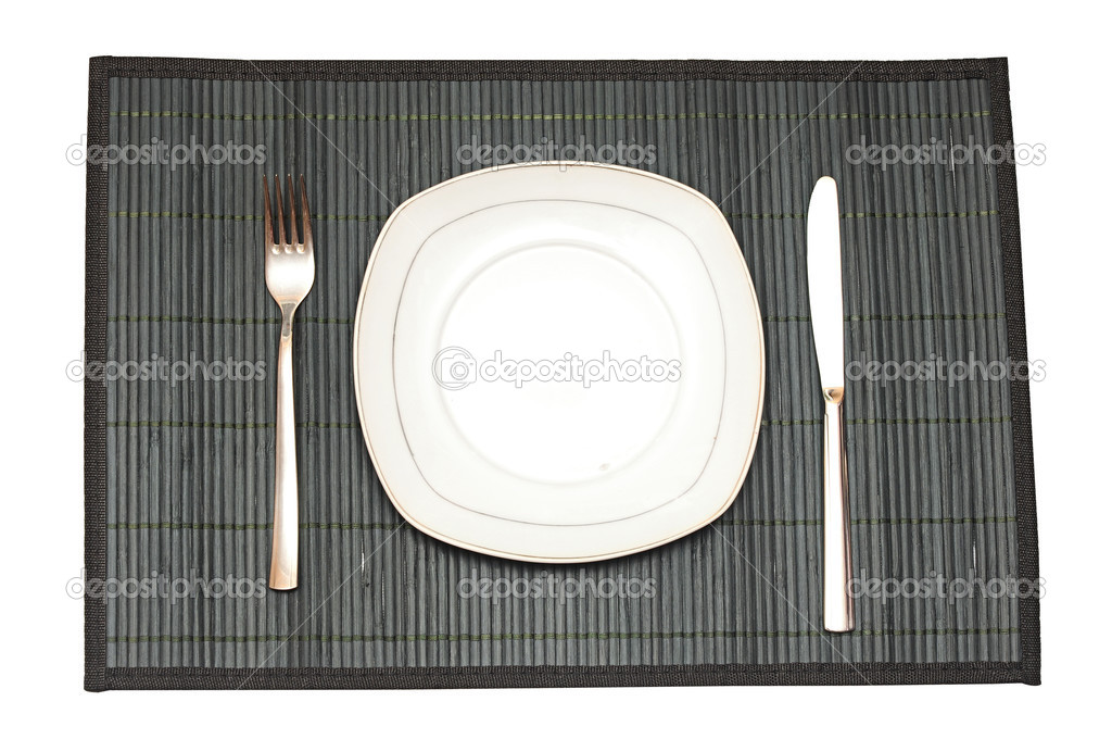 Bamboo placemat with plate fork and knife isolated on white