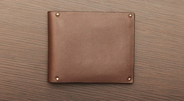 Leather purse on wood background — Stock Photo, Image