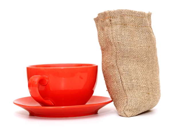 Red cup of coffee with sack of coffee beanson white background — Stock Photo, Image