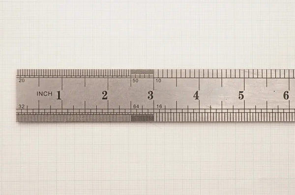 Steel ruler on paper graph — Stock Photo, Image