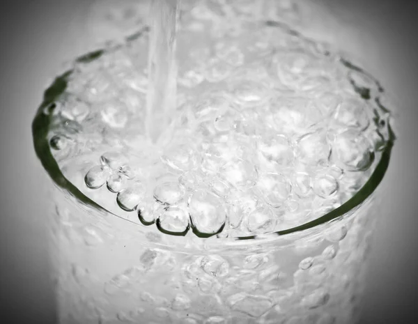 Pouring water into the glass — Stock Photo, Image