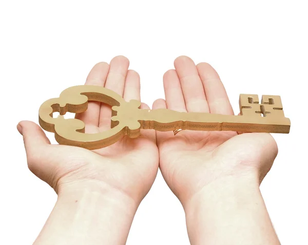 Gold key in hands of the person isolated on white background — Stock Photo, Image