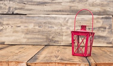 red vintage lamp on rustic wooden table clipart