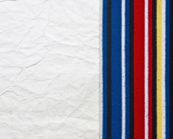 Old paper on border colorful stripe fabric — Stock Photo, Image