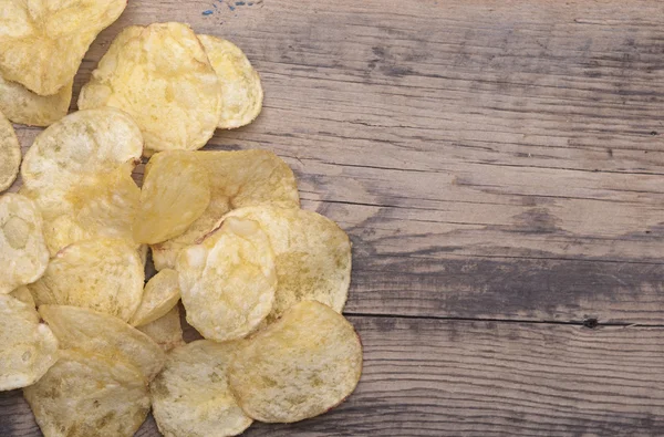 Group of potato chips close-up on wooden surface. — Stock Photo, Image