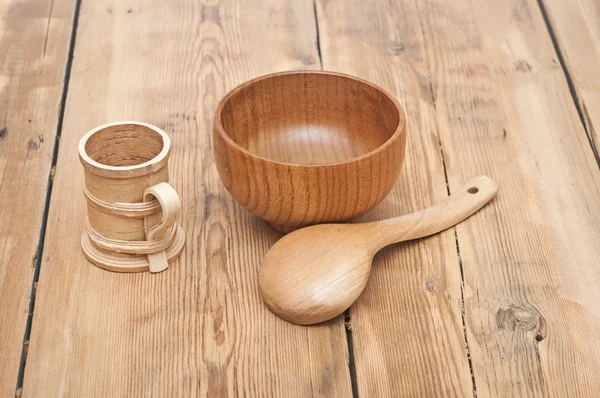 Wooden kitchen utensils on wooden table — Stock Photo, Image