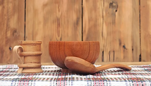 Wooden kitchen utensils on wooden table — Stock Photo, Image