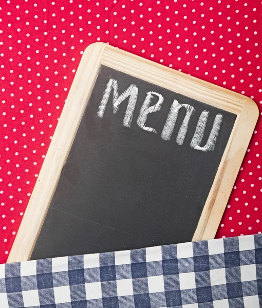 Menu title written with chalk on blackboard lying on tablecloth — Stock Photo, Image