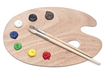 Photo of a wooden artists palette loaded with various colour pai