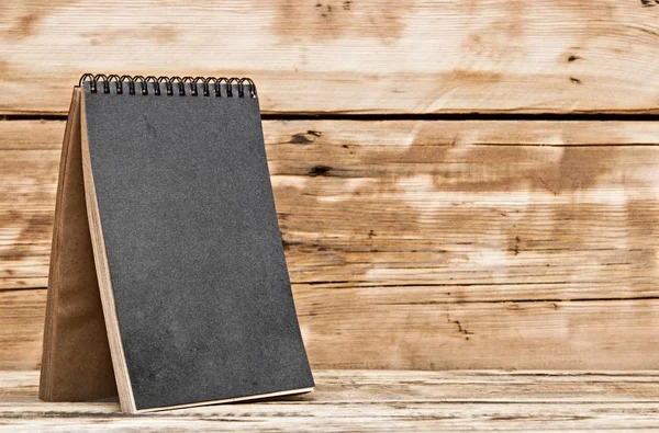 Blank desk calendar on old wooden table — Stock Photo, Image