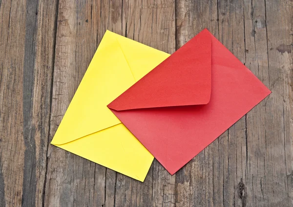 Colorful envelopes lying on old wooden table — Stock Photo, Image