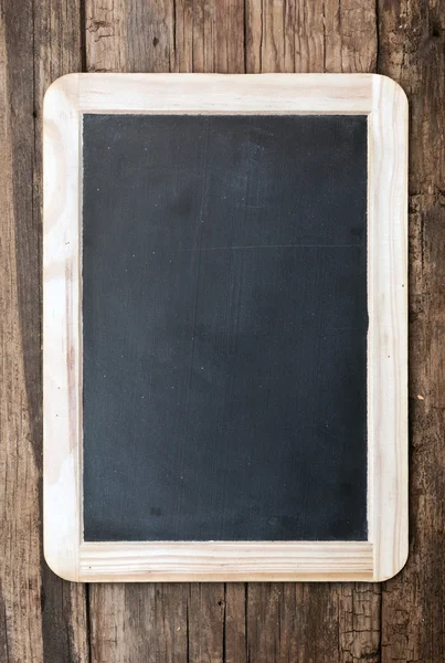 Vintage chalkboard hanging on old wooden background — Stock Photo, Image