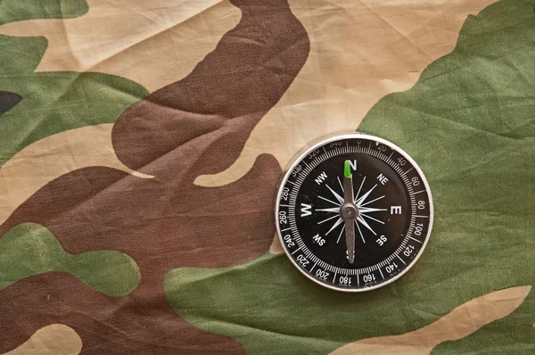 Compass on a camouflage background — Stock Photo, Image