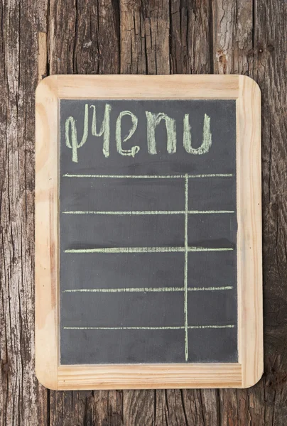 Word "menu" writen on aged blackboard and hanging on wooden wall — Stock Photo, Image