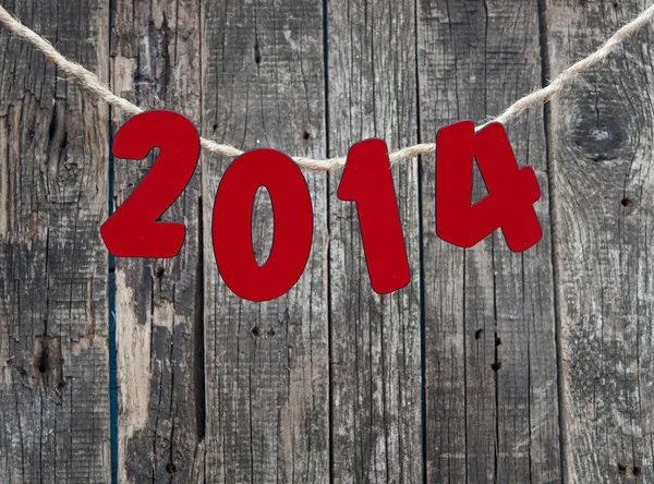 2014 New Year hanging rope on old wood background. — Stock Photo, Image