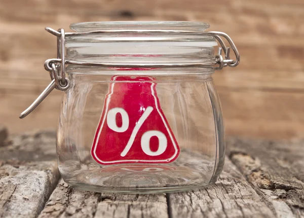 Sign percent in a glass jar on wooden table — Stock Photo, Image