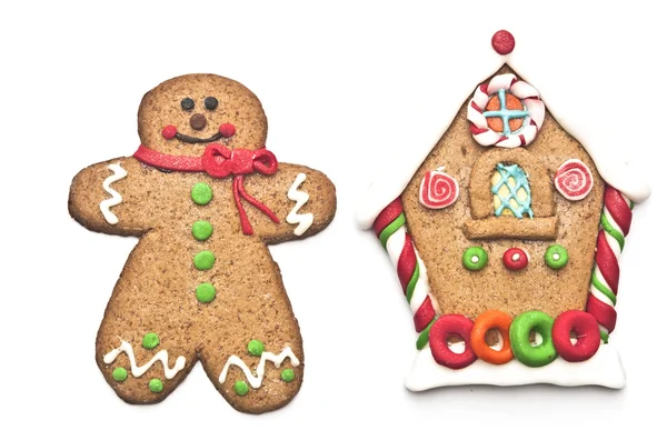 Gingerbread house with gingerbread man on white background — Stock Photo, Image