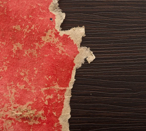 Hole ripped in red paper on black background. Copy space — Stock Photo, Image