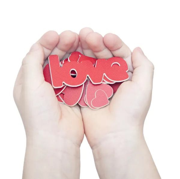 As mãos seguram uma palavra "amor" no fundo branco — Fotografia de Stock