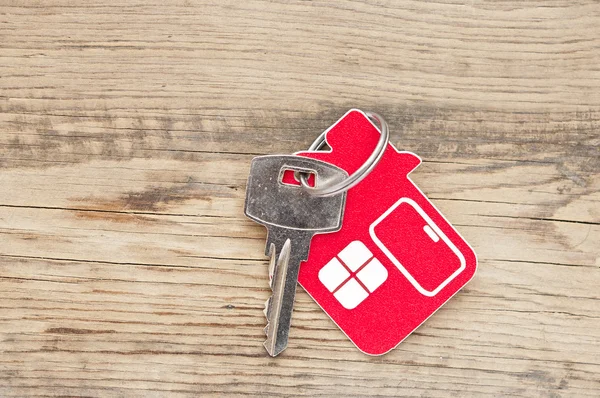 A key in a lock with house icon on it — Stock Photo, Image