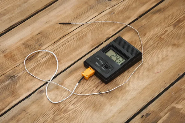 Digital thermometer on wooden table top — Stock Photo, Image