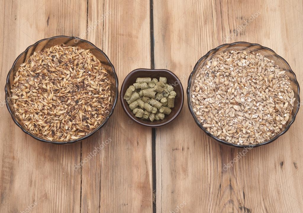 Beer ingredients, hops and malt on wooden table top Stock Photo by