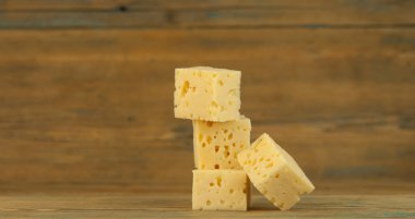 Peynir küplerini ahşap mutfak masasına yığın.