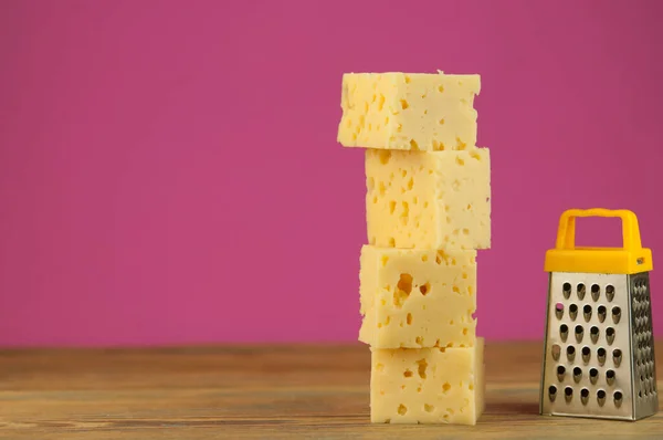 Käsewürfel Mit Miniaturreibe Auf Einem Holztisch Stapeln — Stockfoto