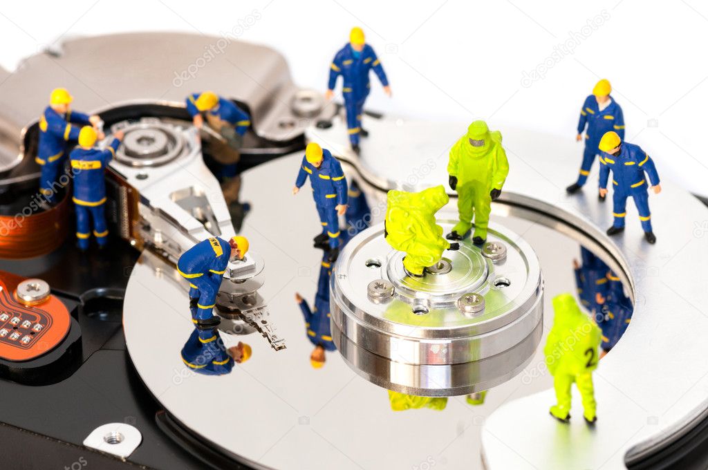 Group of engineers maintaining hard drive