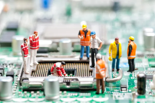 Team of engineers repairing circuit board — Stock Photo, Image