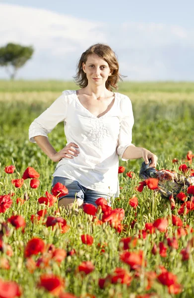 Girl jumping in red poppies field — Stock Photo, Image