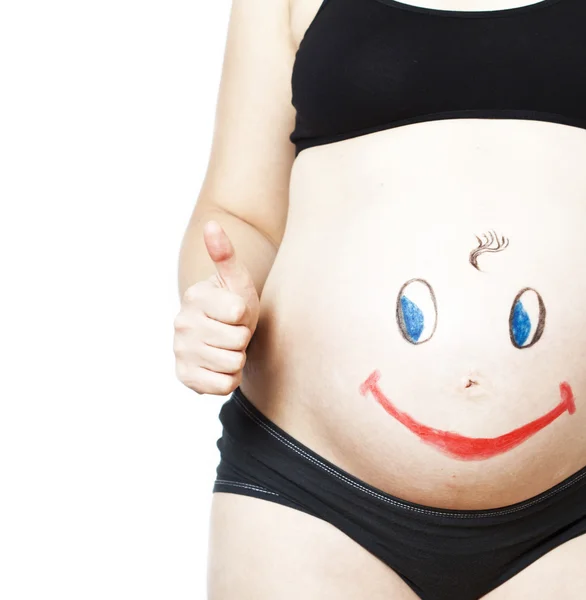 Cara sonriente feliz pintada en el vientre de la mujer embarazada —  Fotos de Stock