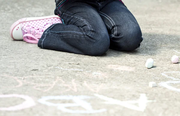 Back to school concept - Photo of girl writing with chalk on the schoolyard — Stock Photo, Image