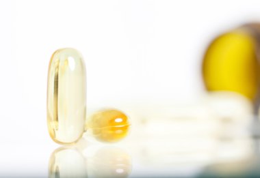 arka planda hapı şişesiyle sarı haplar