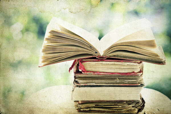 Vintage photo of old books on colorful bokeh background
