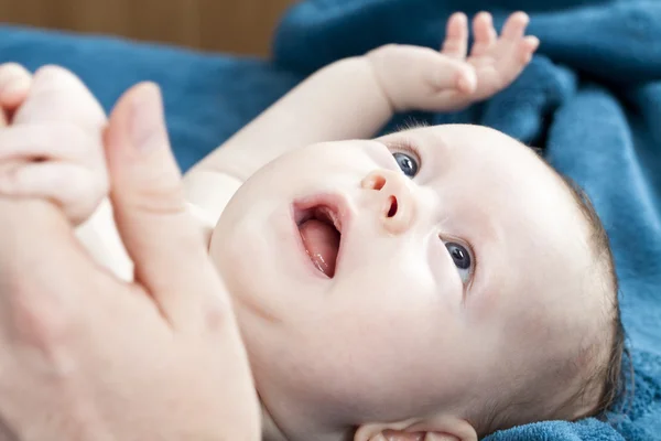 Cute baby playing on blue blanket — Stock Photo, Image