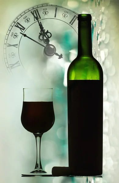 Red wine against holiday lights and clock — Stock Photo, Image