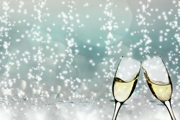 Glasses with champagne against holiday lights — Stock Photo, Image